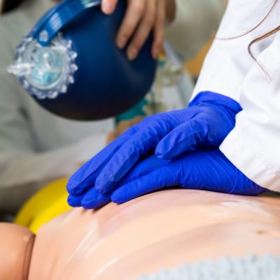 Medical Students practicing emergency cardiopulmonary resuscitation on a medical practice doll for emergencies